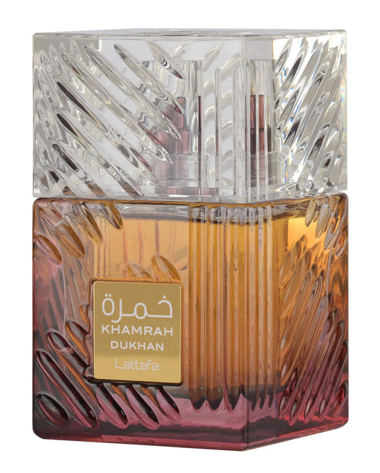 Perfume bottle with intricate design and 'Khamrah Dukhan' branding on a white background