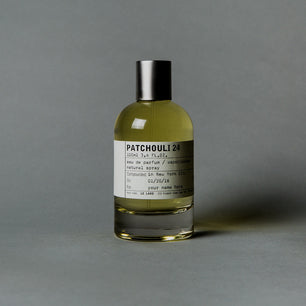 Perfume bottle labeled 'Patchouli 24' on a gray background
