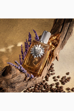 Perfume bottle with decorative cap on a rustic background with lavender and coffee beans