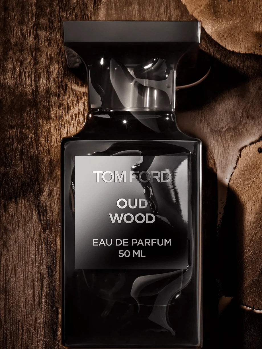 Tom Ford Oud Wood Eau de Parfum bottle on a textured brown background