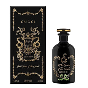 Gucci perfume bottle and packaging with decorative elements on a white background