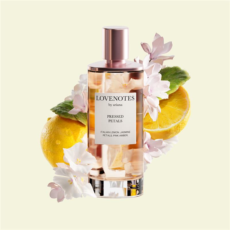 Perfume bottle labeled 'Lovenotes by ariana' with lemons and flowers on a light yellow background