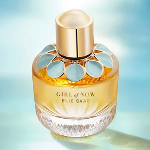 Perfume bottle labeled 'Girl of Now' by Elie Saab on a gradient blue background