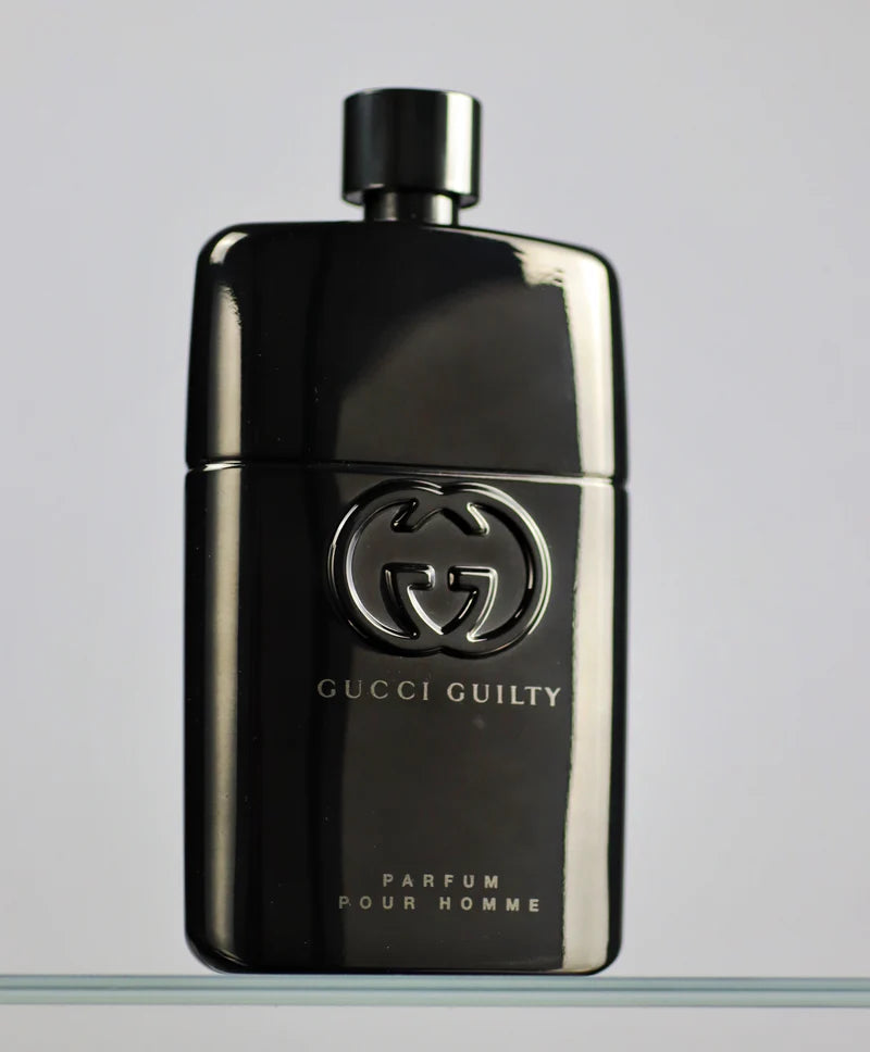Gucci Guilty perfume bottle on a gray background