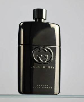 Gucci Guilty perfume bottle on a gray background