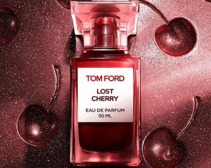 Tom Ford Lost Cherry perfume bottle with cherries on a red background