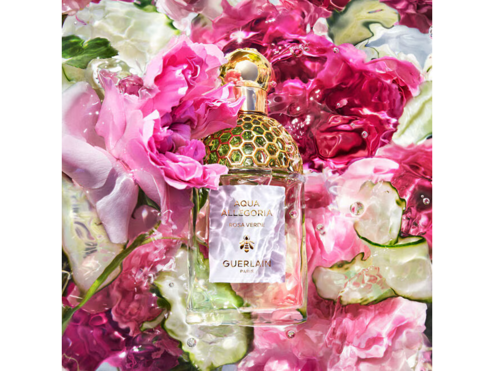 Perfume bottle with gold cap on a floral and cucumber background