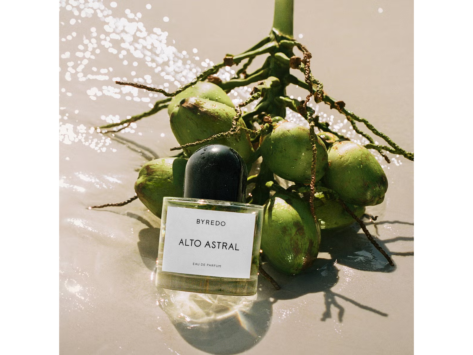 Byredo Alto Astral perfume bottle with coconuts on a beach setting