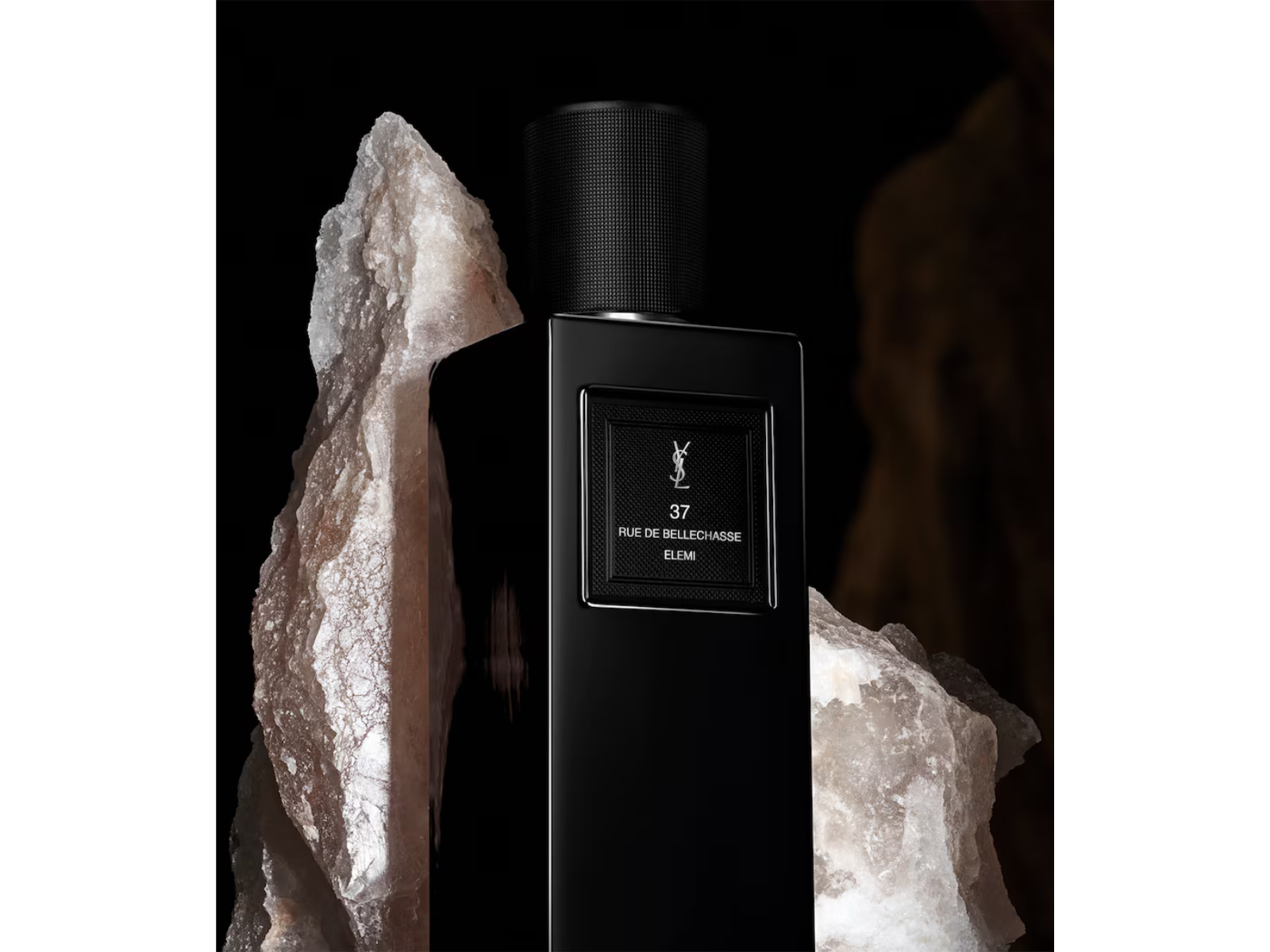 Black perfume bottle with YSL logo against a dark background