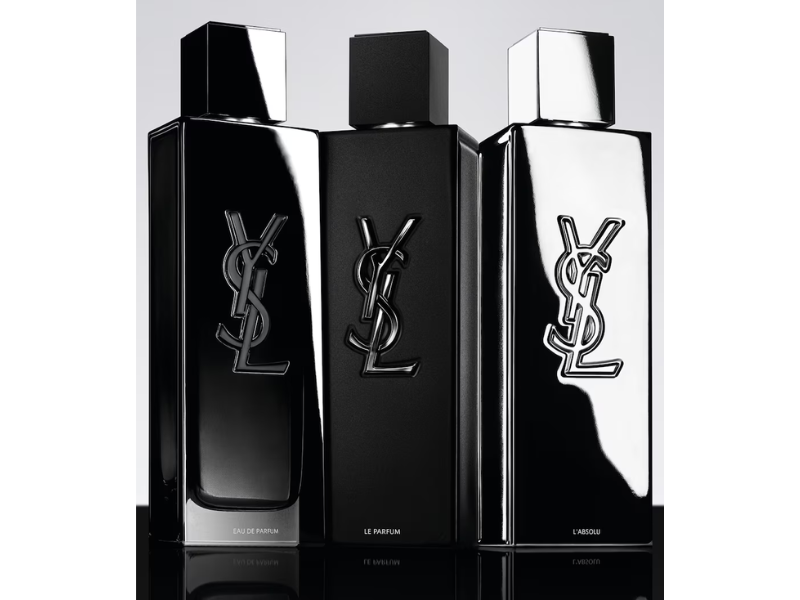 Three YSL perfume bottles on a reflective surface with a light gray background