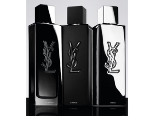Three YSL perfume bottles on a reflective surface with a light gray background