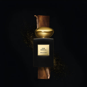 Perfume bottle with gold cap and 'Cuir Zellige' label on a dark background