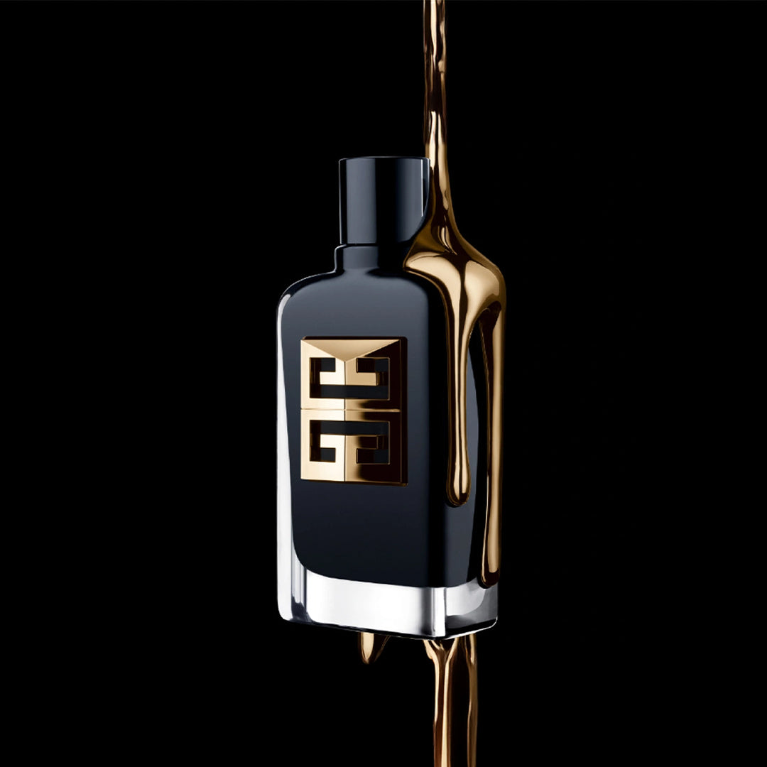 Black perfume bottle with gold accents on a black background