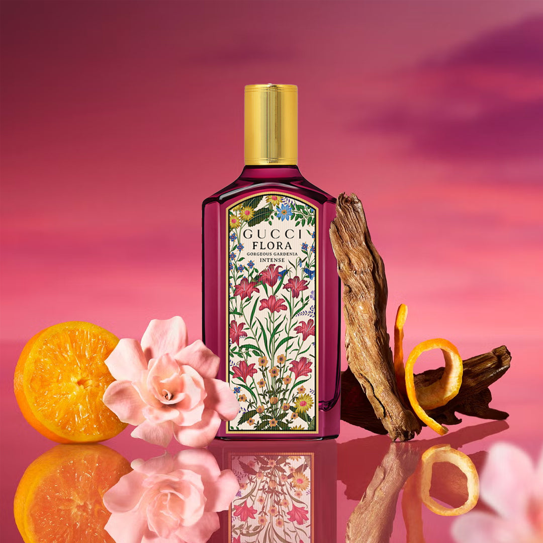 Gucci Flora perfume bottle with floral design on a pink background
