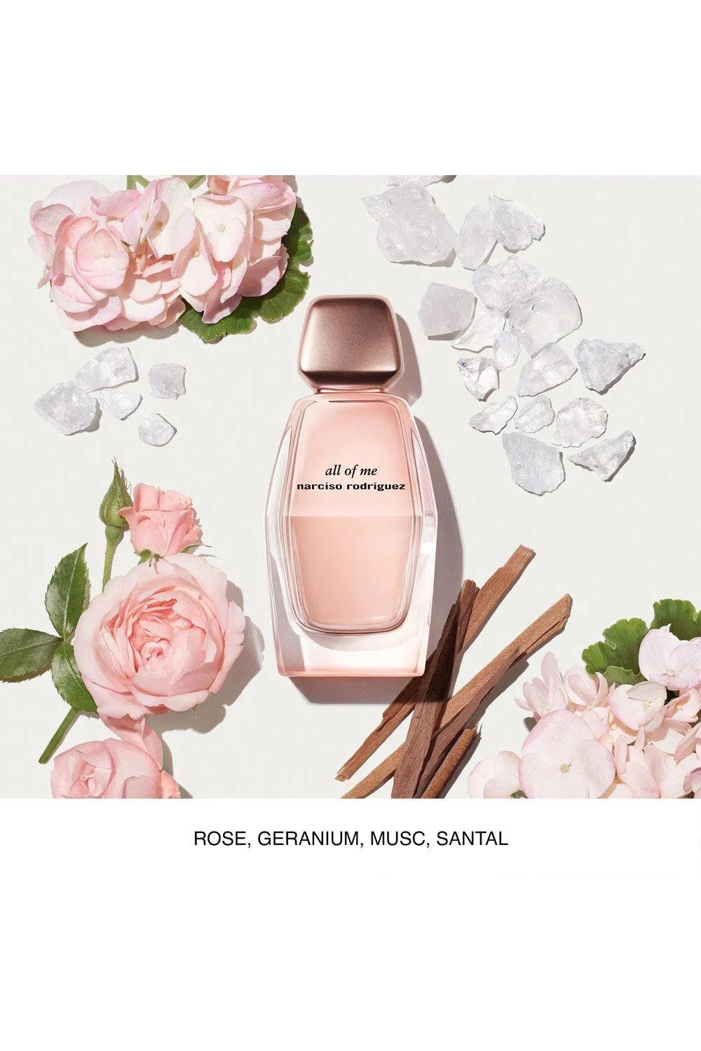 Pink perfume bottle with floral elements on a light background